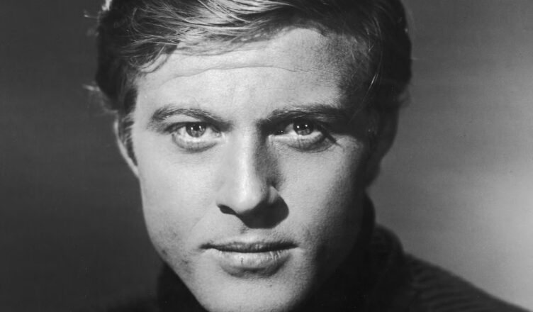 Black and white close-up portrait of a young man with intense eyes.