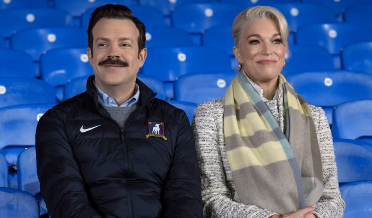Ted Lasso Episode 401 Preview image from "Home" featuring Ted Lasso and Rebecca Welton at AFC Richmond as Season 4 begins.